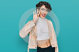 Handsome man wearing make up and woman clothes showing and pointing up with fingers number four while smiling confident and happy