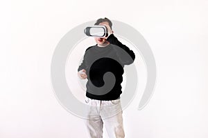 Handsome man wearing and playing virtual reality on isolated white background. Boy action in virtual reality helmet. VR glasses.