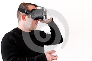 Handsome man wearing and playing virtual reality on isolated white background. Boy action in virtual reality helmet. VR glasses.