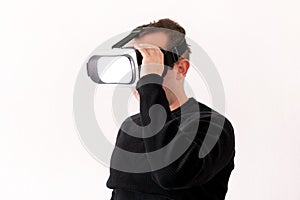 Handsome man wearing and playing virtual reality on isolated white background. Boy action in virtual reality helmet. VR glasses.