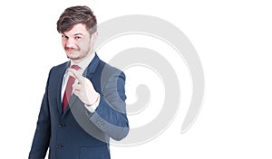 Handsome man wearing suit making fingers crossed gesture