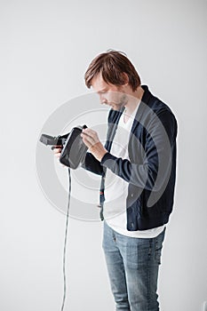 Handsome man wearing virtual reality glasses isolated on a gray background