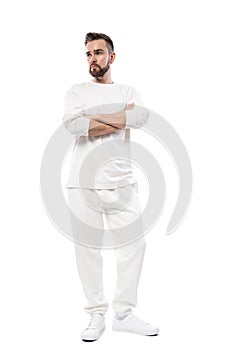 Handsome man wearing white long-sleeved t-shirt and pants on white background