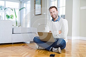 Handsome man wearing working using computer laptop happy face smiling with crossed arms looking at the camera