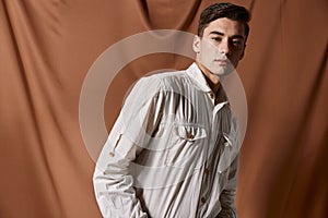 handsome man white shirt brown cloth on background