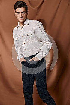 Handsome man white shirt modern style self-confidence hands in pockets