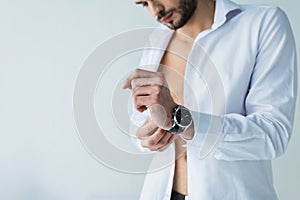 handsome man in white shirt wearing wristwatch,