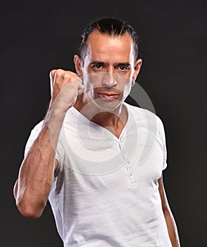 Handsome man in white T-shirt posing in studio