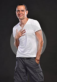 Handsome man in white T-shirt posing in studio