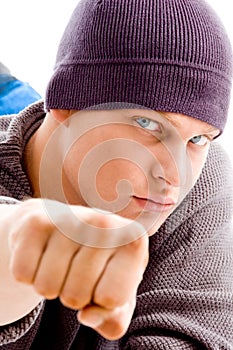 Handsome man with winter cap showing fist