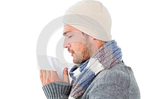 Handsome man in winter fashion blowing his nose