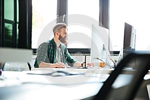 Handsome man work in office using computer.