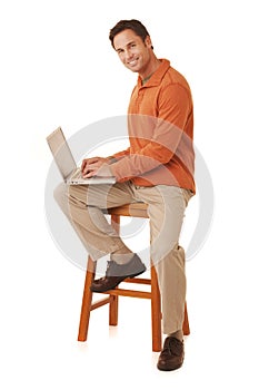 Handsome man working on a laptop computer