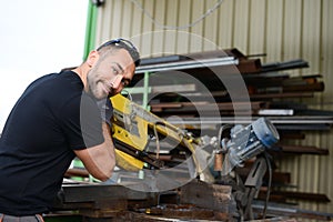 Handsome man working in a workshop steel industry factory construction with a metallurgy machine site