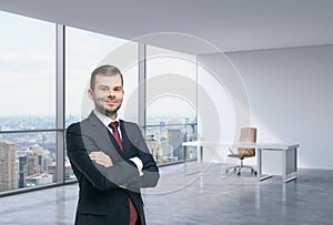 A handsome man in a workplace at modern corner panoramic office in New York, Manhattan. A concept of financial consulting