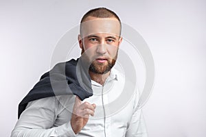 Handsome manful businessman holding his jacket over shoulder on white background