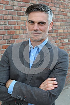 Handsome mature businessman smiling crossing his arms