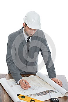 Handsome mature contractor drawing a building plan