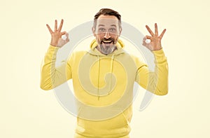 handsome mature man with beard and moustache in hoody isolated on white show ok gesture, perfection
