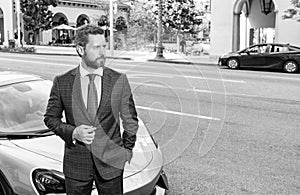 handsome mature man in businesslike suit stand by luxury car outdoor, copy space, success.