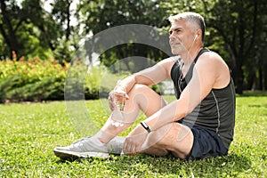 Handsome mature man having rest after exercise. Healthy lifestyle