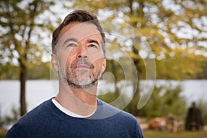 Handsome Mature Man lost in thought. Looking the sky. He is a dreamer.