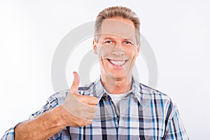 Handsome mature man showing gesture thumb up