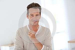 Handsome mature man standing at home