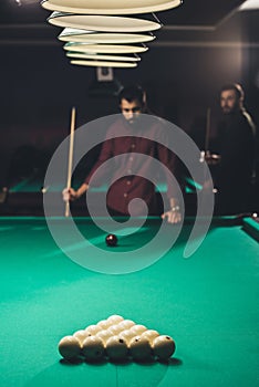 handsome men playing in russian pool