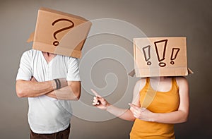 Handsome men in suit gesturing with drawn question marks on box