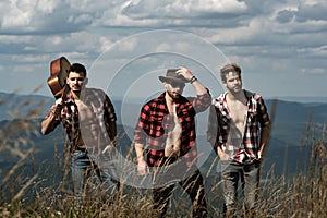 Handsome men walking in the mountains. Group of people man hiking through countryside. Three young mens friends on a