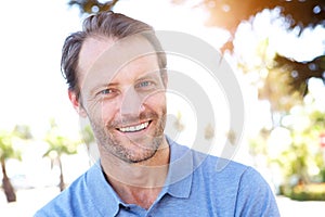 Handsome middle age man smiling outdoors