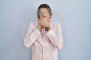 Handsome middle age man wearing elegant shirt background shocked covering mouth with hands for mistake