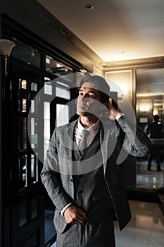 Handsome middle aged businessman in suit standing in a lobby