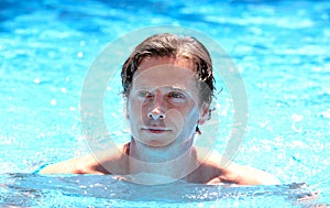 Handsome middle aged man swimming in outdoor pool