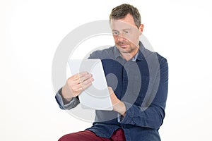 Handsome middle aged man is using a tablet computer on white background