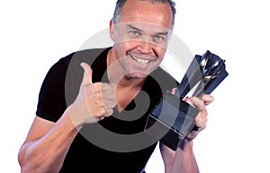 Handsome middle aged man with winners trophy