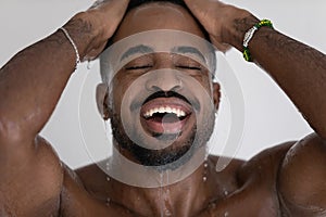 Handsome mixed race black man relaxing and taking shower