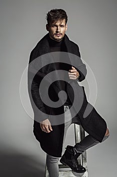 Handsome model in black long coat