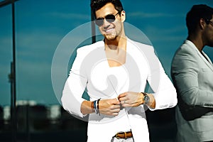 Handsome model man in casual suit in sunglasses