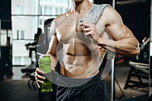 Handsome model young man takes sports nutrition