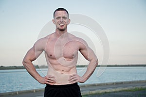 Handsome muscle man near of river