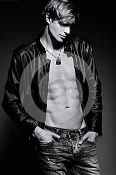 Handsome muscled fit male model man in leather jacket