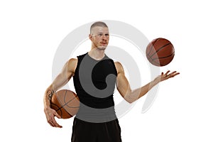 Handsome muscled man, basketball player posing with two balls isolated on white studio background. Sport, motion