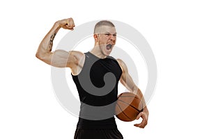 Handsome muscled man, basketball player standing with basketball balls isolated on white studio background. Sport