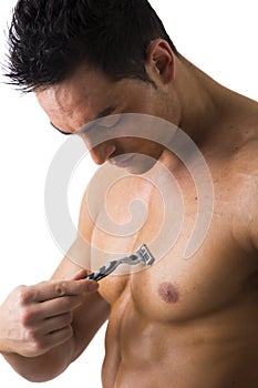 Handsome Muscled Young Man Shaving his Chest