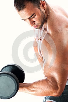 Handsome muscular bodybuilder posing with dumbbell