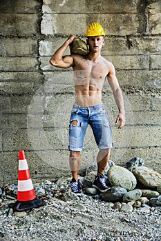 Handsome muscular construction worker standing