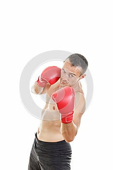 Handsome muscular male boxer ready to fight with boxing gloves