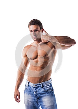 Handsome muscular male model doing call me gesture